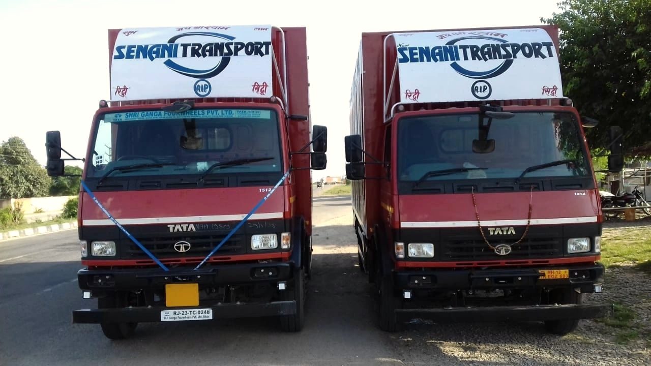 Two Senani Transport container trucks parked side by side