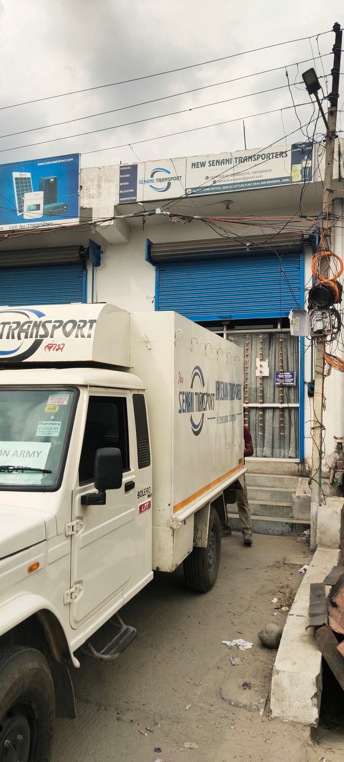 Senani Transport pickup truck with an 'ON ARMY DUTY' windshield board outside the Bari Brahmana depot